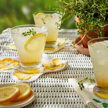 refreshing beverages with lemon and thyme garnishes on a table